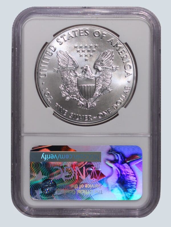 A silver eagle is shown next to an image of the american flag.