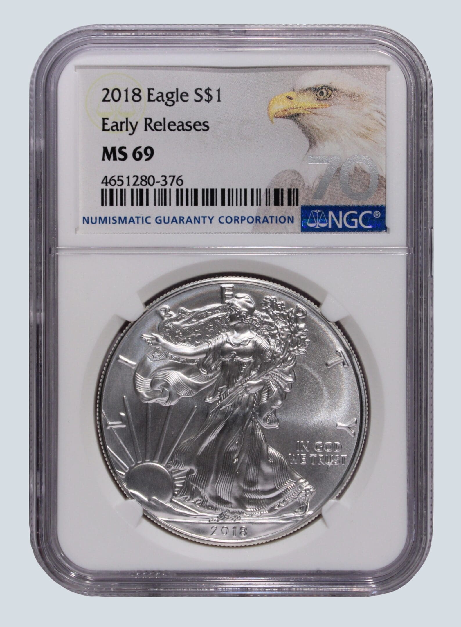 A silver eagle coin is on the back of an ngc slab.