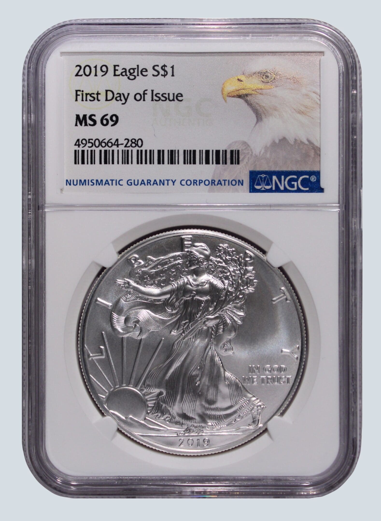 A silver eagle coin is on the first day of issue.