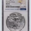A silver eagle coin is on the first day of issue.