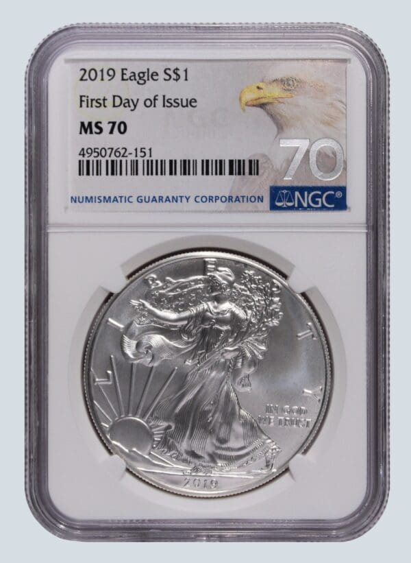 A silver eagle coin is on the first day of issue.