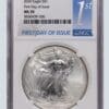 A silver eagle coin is on the first day of issue.