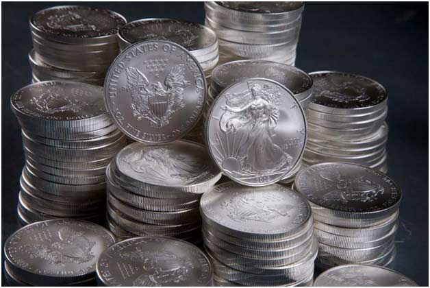 A pile of silver coins sitting on top of each other.